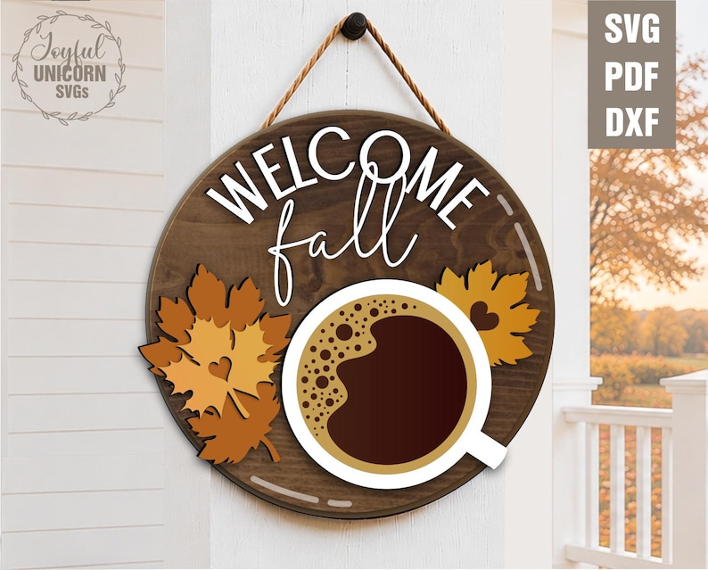 May include: A round wooden sign with the words "WELCOME fall" in white script. The sign features a coffee cup, fall leaves, and a rope for hanging. The sign is a fall-themed decoration.