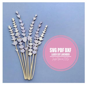 May include: A bundle of laser-cut lavender stems with light purple flower heads and natural wood stems, arranged against a light blue background. The image includes a pink circle with the text "SVG PDF DXF LASER CUT LAVENDER".