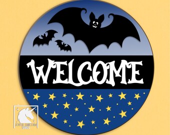 May include: A round, layered design with a Halloween theme. The top section features black bats against a light blue background. The word "WELCOME" is in white, bold letters. The bottom section has a dark blue background with yellow stars. Text at the top says "HIGH QUALITY FILES SVG | PDF | DXF".