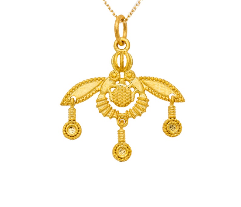 Beautiful bee necklace in solid gold inspired by the ancient Greek Malia honey bee pendants from the island of Crete. It pictures two bees facing one another with 3 tiny gold dots hanging from their wings and stings (center).