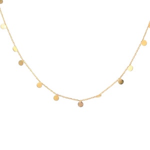 A solid gold necklace with tiny gold discs, dots dangling from the chain. Available in 9k, 14k or 18k solid yellow, white or rose gold.