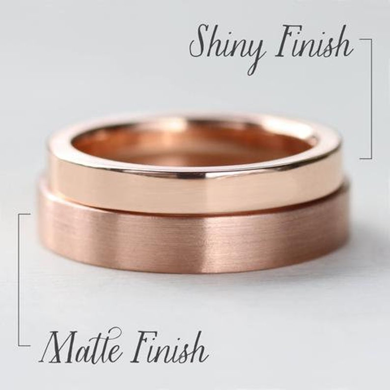 May include: Two stacked rose gold rings. The top ring features a smooth, reflective shiny finish. The bottom ring features a textured, brushed matte finish. Text in the image indicates Shiny Finish for the top ring and Matte Finish for the bottom ring.