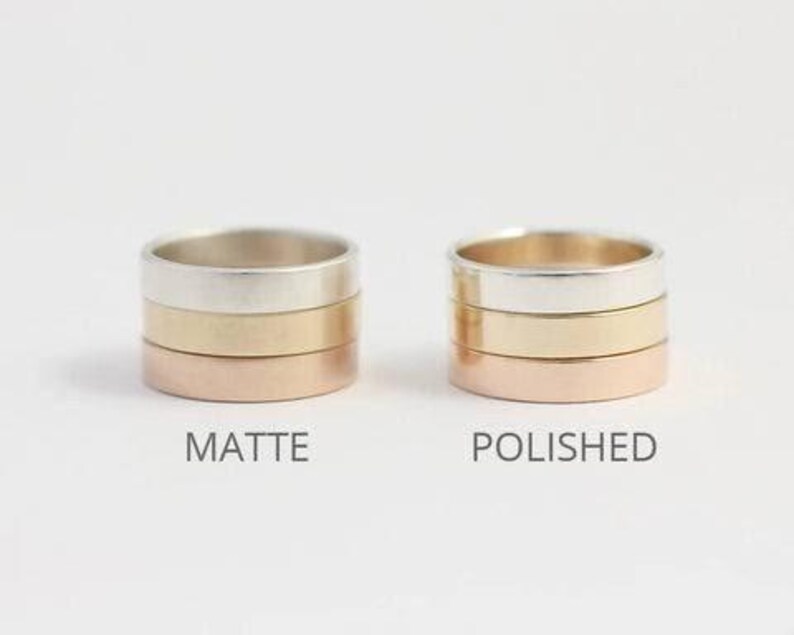 May include: Two stacks of three metal rings each. The left stack has a matte finish, and the right stack has a polished finish. Each stack contains a silver-colored ring, a gold-colored ring, and a rose gold-colored ring. The text MATTE and POLISHED appears below the respective stacks.