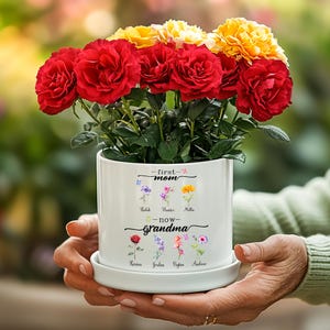 May include: White ceramic planter with the text "first mom - now grandma" and a floral design. The planter has the names of five children and five flowers.