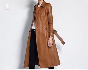May include: A long brown leather trench coat with a double breasted closure, a belt, and a classic collar.
