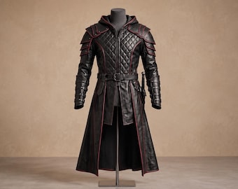 May include: A black long-coat with a hood, featuring a quilted chest panel, layered shoulder armor, and red piping accents. The garment includes a waist belt with a buckle, long sleeves with segmented forearm details, and a knee-length skirt.