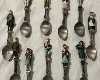 May include: Set of ten silver spoons with miniature figurines of characters from classic literature. Each spoon features a different character, including David Copperfield, Little Nell, and Mr. Micawber. The spoons are engraved with the character's name.