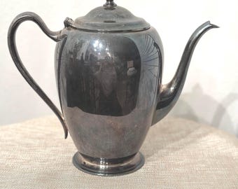 May include: A silver teapot with a rounded body and a lid with a knob on top. The teapot has a spout and a handle.