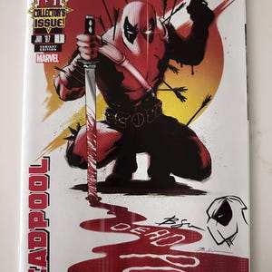 May include: A Deadpool comic book cover featuring the character in a dynamic pose, holding a sword and a gun, with arrows piercing his body. The cover is predominantly red and white, with the title "Deadpool" prominently displayed.