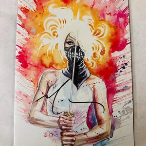 May include: A comic book cover featuring a watercolor illustration of a figure with blonde hair, wearing a black mask with white teeth, holding a sword vertically. The background is a vibrant red and orange splash. The text 'something' is visible.