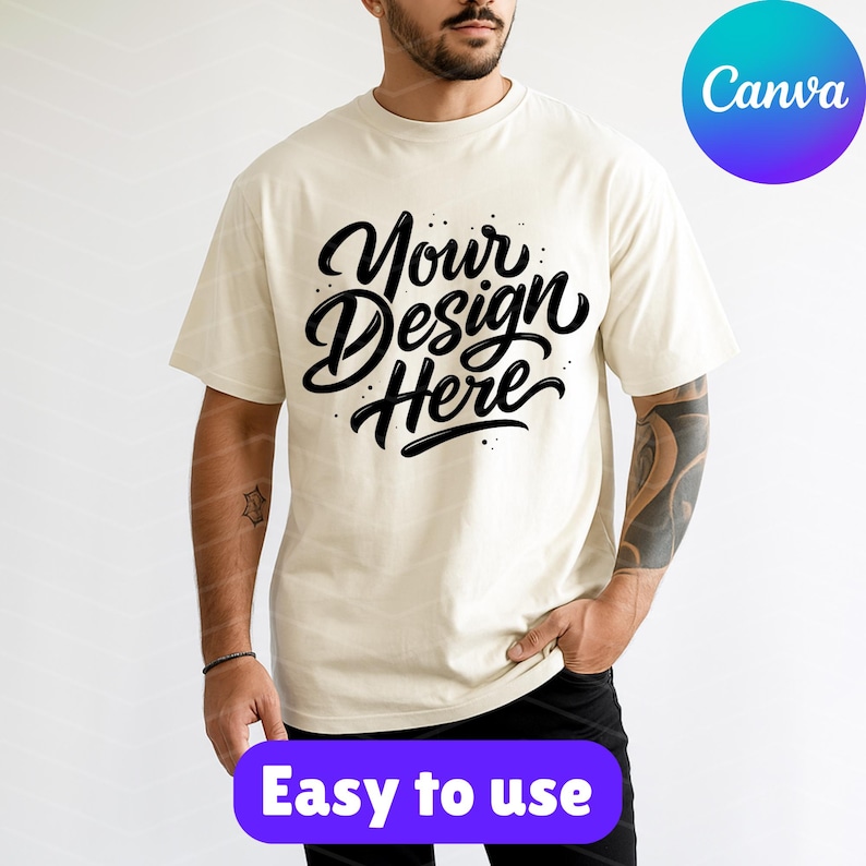May include: Cream-colored t-shirt with the text "Your Design Here" in a black, cursive font. The shirt also has the text "Easy to use" in a purple box. A Canva logo is in the upper right corner.