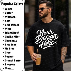 May include: Black t-shirt with the text "Your Design Here" in white script. The image also shows a list of popular colors, including white, butter, and mustard. The person in the image is wearing sunglasses and holding a beverage.