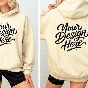 May include: Cream-colored hoodie with a front pocket and drawstring hood. The front and back of the hoodie feature the text "Your Design Here" in a black, stylized script. The model is wearing black shorts.