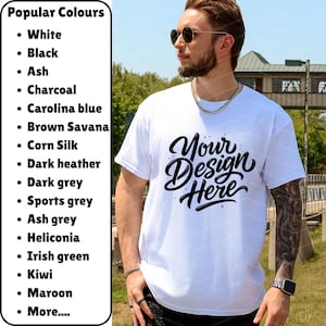 May include: A white t-shirt with the text "Your Design Here" in a black, cursive font. The shirt is being worn by a person. A list of popular colors is on the left side of the image.