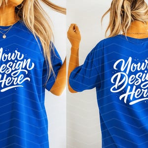 May include: A royal blue t-shirt with the text "Your Design Here" in white script on the front and back. The shirt has a relaxed fit and a subtle chevron pattern.