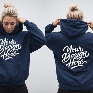 May include: Navy blue hoodie with the text "Your Design Here" in white script on the front and back. The hoodie has a front pocket and a hood. The model is wearing the hoodie.
