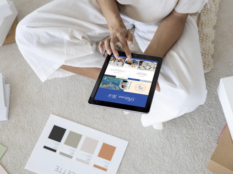 May include: A person is using a tablet to view a website called "Brillante Media". The website features a blue and white color scheme and includes images of various products. The tablet is on a white surface.