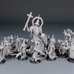May include: A collection of unpainted miniature figurines, likely for tabletop gaming. The figures include armored characters with weapons, a large central figure with a cross, and figures with banners. The bases are black.