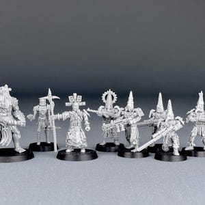 May include: A set of eight unpainted miniature figures, made of grey plastic, depicting a group of warriors with various weapons and armour. The figures are posed in a variety of dynamic stances, ready for battle.