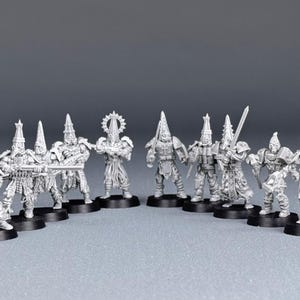 May include: A set of ten unpainted miniature figures, each wearing a pointed helmet and holding a weapon. The figures are made of metal and are ready to be assembled and painted.