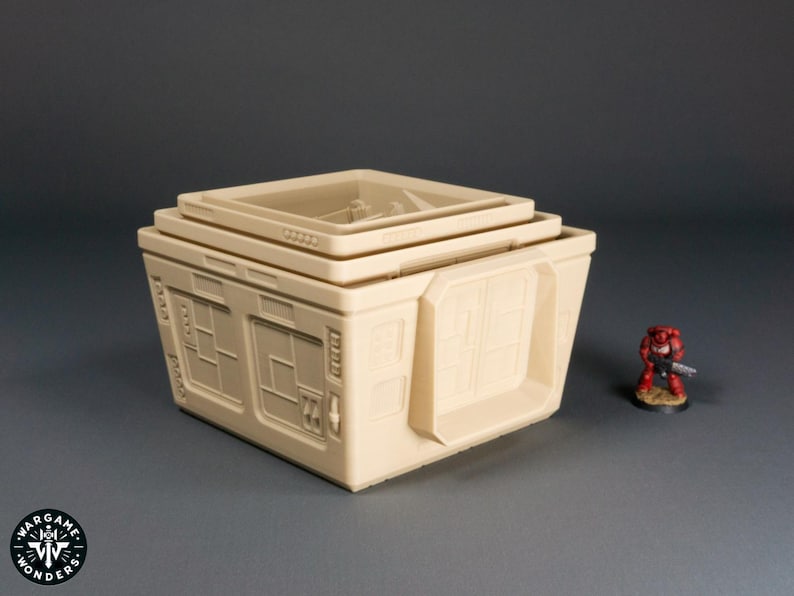 May include: A beige, multi-level, modular building with windows and a door. The building is made of plastic and is designed for use in tabletop games.