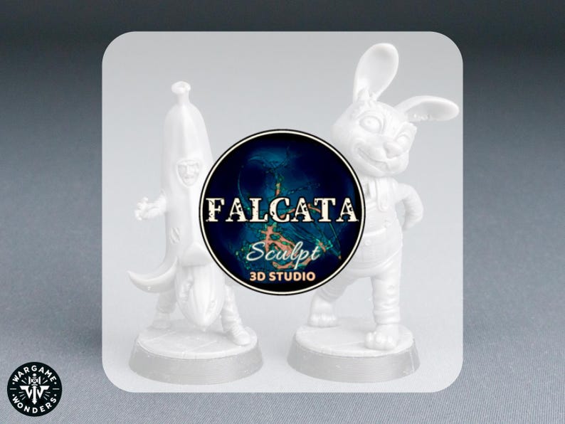 May include: Two white 3D-printed figurines: a banana with a face and a rabbit wearing overalls. The figurines are on a gray surface. A circular logo with the text "FALCATA Sculpt 3D STUDIO" is between them.
