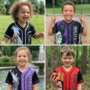 May include: Four children wearing baseball jerseys featuring Disney villains. The jerseys are black, red, and purple with character graphics and names like "Cruella," "Maleficent," "Ursula," and "Evil Queen." One child holds an apple.