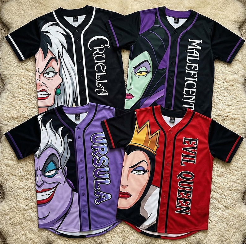 May include: Baseball jerseys featuring villainous characters Cruella, Maleficent, Ursula, and the Evil Queen. Each jersey has a character's face on the front and the character's name printed vertically. The jerseys are black, red, and purple with contrasting sleeves and trim.