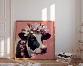 May include: A framed art print featuring a black and white cow wearing a floral crown of white and pink flowers. The cow is set against a pink background. The wooden frame adds a rustic touch to the artwork.