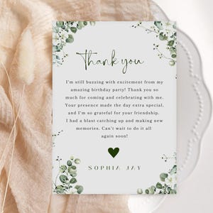 May include: A thank you card with a green heart and floral design. The text reads "Thank you. I'm still buzzing with excitement from my amazing birthday party! Thank you so much for coming and celebrating with me. Your presence made the day extra special. And I'm so grateful for your friendship. I had a blast catching up and making new memories. Can't wait to do it all again soon!" and "SOPHIA JAY".