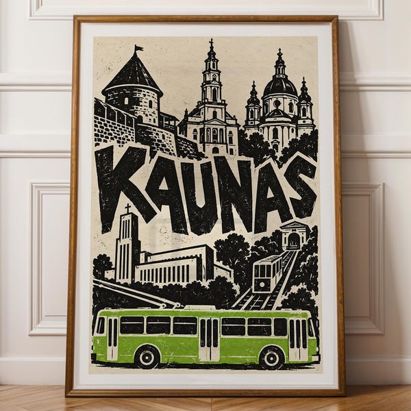 May include: A framed print featuring a black and white illustration of the city of Kaunas, Lithuania, with the word KAUNAS in large bold letters. The artwork depicts historic buildings, a funicular, and a bright green trolleybus.