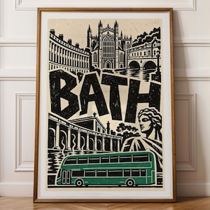 Puede incluir: Una impresión enmarcada con una ilustración gráfica en negro y crema de la ciudad de Bath. La obra muestra la palabra BATH en letras grandes, la Abadía de Bath, el puente Pulteney, una estatua clásica y un autobús de dos pisos verde abajo.