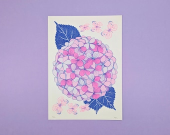May include: A print of a pink and purple hydrangea with blue leaves and pink butterflies. The print has a white background and is signed in the bottom right corner.