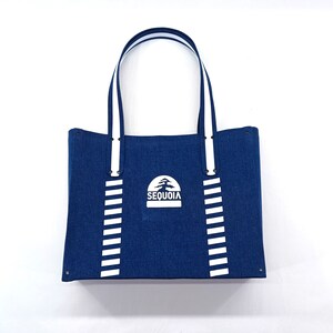 May include: A blue canvas tote bag with white stripes and a white logo that says "SEQUOIA" with a stylized tree design.