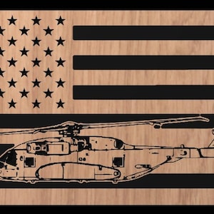 May include: Wooden wall art featuring the American flag design with a detailed illustration of a helicopter. The flag's stars and stripes are in black, set against a natural wood grain background. The helicopter is also in black.
