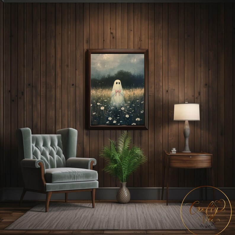 May include: A painting of a white ghost standing in a field of white flowers. The ghost is wearing a pink ribbon around its neck. The painting is framed in a dark wood frame and is hanging on a dark wood wall.