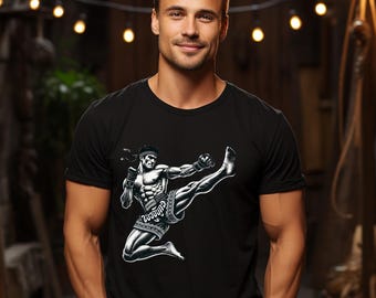 May include: Black t-shirt with a graphic of a man in a fighting pose, wearing a headband and shorts with the word "Muay Thai" written on them.