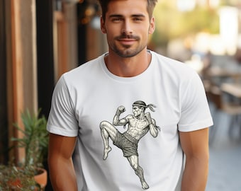 May include: White t-shirt with a black and white illustration of a man in a fighting pose. The man is wearing a headband and shorts.
