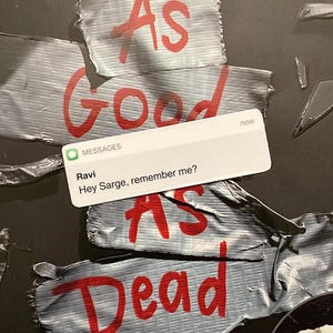 May include: A close-up of a text message on a phone screen. The message reads "Hey Sarge, remember me?" and is from a contact named "Ravi". The message is overlaid on a background of duct tape with the words "As Good As Dead" written in red.