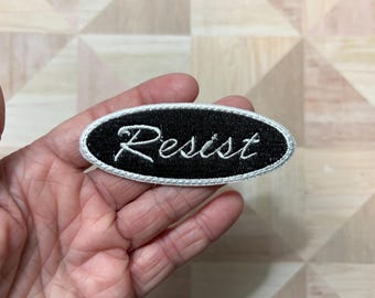 Resist, Brush Script Oval Name Badge