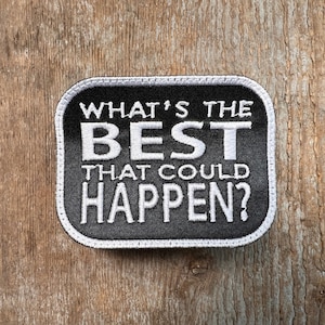 May include: Black patch with white stitching and the text "What's the best that could happen?"