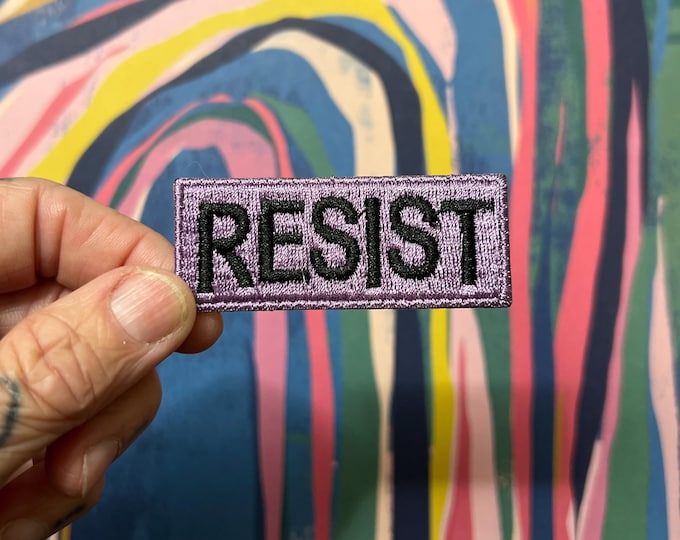 RESIST - Wee little violet patch with block lettering