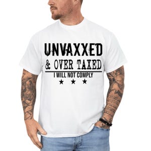 May include: White t-shirt with black text that reads "UNVaxxed & OVER TAXED I WILL NOT COMPLY" with three black stars below the text.