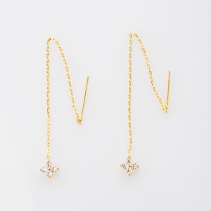 May include: A pair of gold dangle earrings with a small, four-pointed star charm set with clear cubic zirconia stones.