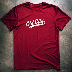 May include: A red t-shirt with a white graphic that says "Old City" in a vintage baseball font.