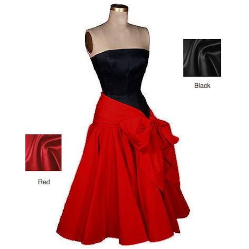 May include: A strapless black bodice with a red skirt and a large red bow. The skirt is full and flowing. The fabric is satin.