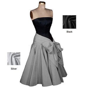 May include: A strapless dress with a black bodice and a silver skirt. The skirt has a large bow at the front.