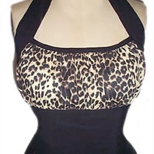 May include: A black halter top with a leopard print bodice. The top has a gathered neckline and a fitted silhouette.