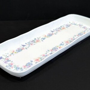 May include: White rectangular serving tray with a floral design in shades of pink, purple, and blue.