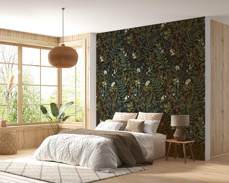 May include: A white bed with a brown blanket and pillows in a bedroom with a large window and a floral patterned wallpaper.